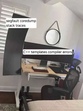 a meme of a computer desk with a monitor displaying C++ templates compiler errors and a text bubble mentioning segfault coredump stack traces