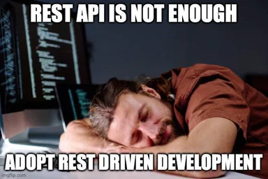 programmer sleeping at desk with computer screens in background