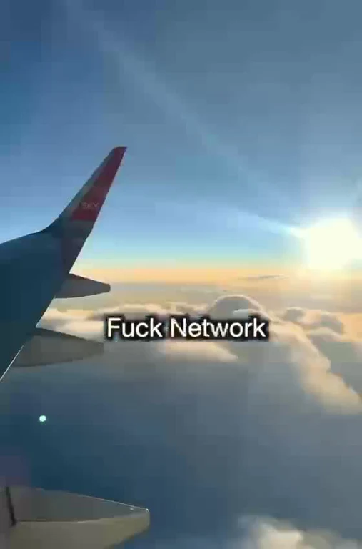 View of an airplane wing above clouds with text saying Fuck Network