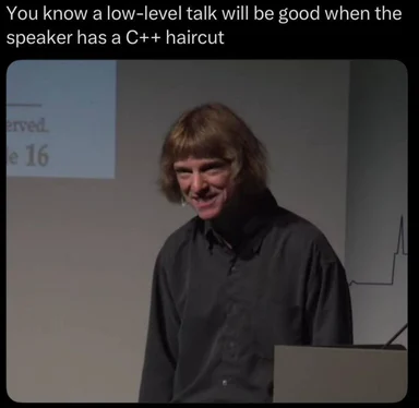a man with a mullet haircut, implying a low-level talk about C++
