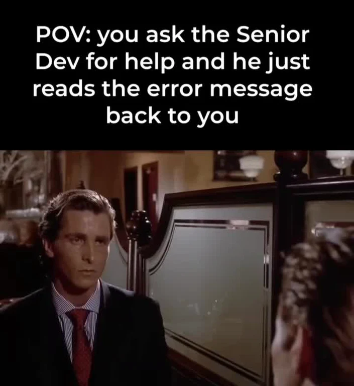 Humorous scene of a senior developer unhelpfully reading an error message back to a junior developer, reaction meme.