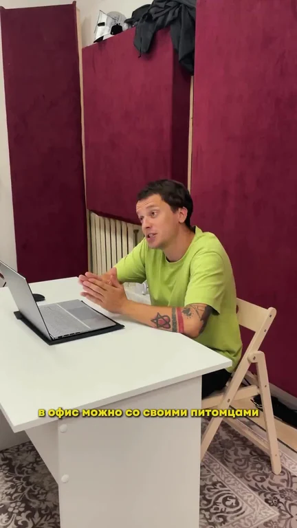 Man sitting at desk with laptop and surprised expression