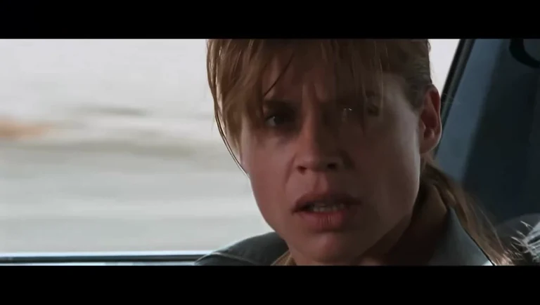 Woman with a shocked or disgusted expression in a car