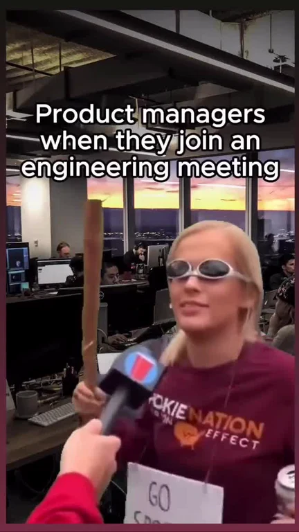a woman wearing sunglasses and a maroon shirt being interviewed with a wooden club