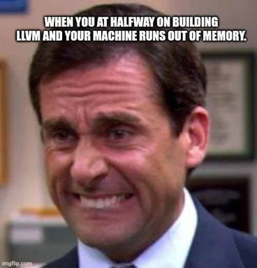 Smiling man in a suit with text 'WHEN YOU AT HALFWAY ON BUILDING LLVM AND YOUR MACHINE RUNS OUT OF MEMORY'
