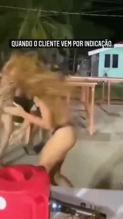 A blurry video of a woman dancing wildly with long hair flying, representing a chaotic party reaction.