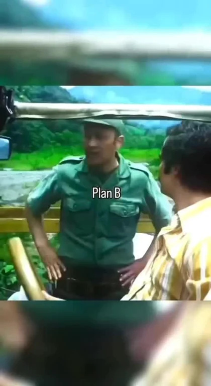 Man in green uniform labeled Plan B standing next to another man