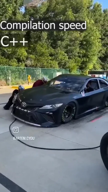 A black drag racing car being towed with the text 'Compilation speed C++' overlaid.