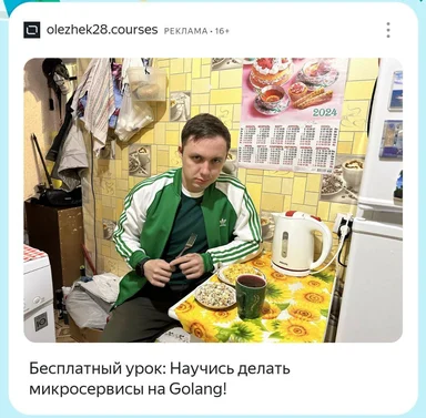 man in green tracksuit sitting at kitchen table with food and drink
