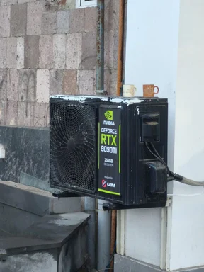 NVIDIA GeForce RTX 9090Ti graphics card installed as an outdoor air conditioning unit with mugs on top