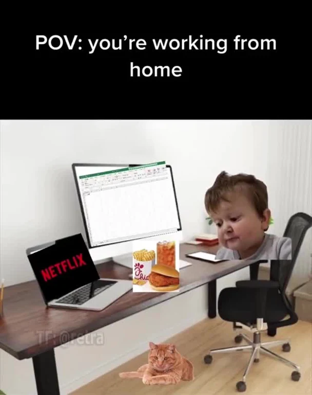 a child sitting at a desk with a computer and food, looking guilty