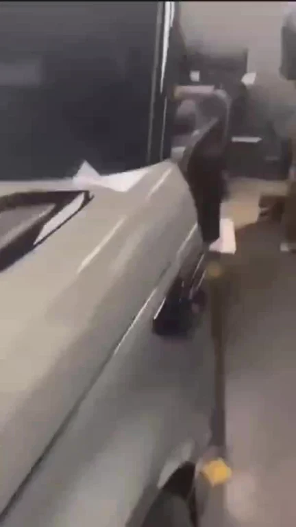A gray car parked inside an office room