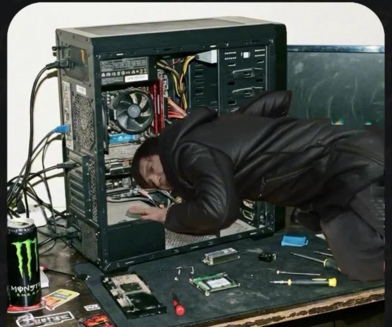 Person crawling inside a computer case to fix hardware