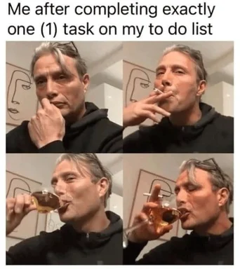 Man celebrating completing one task on his to-do list by smoking and drinking whiskey