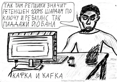 a man sitting at a desk with a computer and a mug, looking stressed