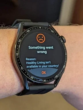Smartwatch displaying error message 'Something went wrong. Reason: Healthy Living isn't available in your country!'