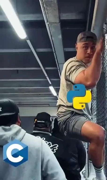Man climbing a fence with a surprised expression, while another man watches