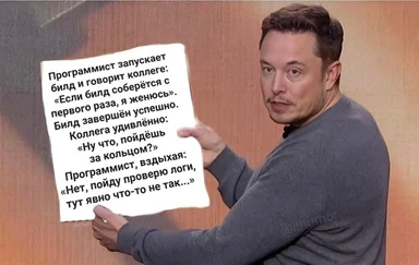 programmer-holds-sign-with-text-about-build-problems