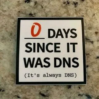 Sticker with text '0 DAYS SINCE IT WAS DNS (It's always DNS)' on a marble background