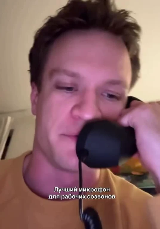 Elon Musk talking on a black headset
