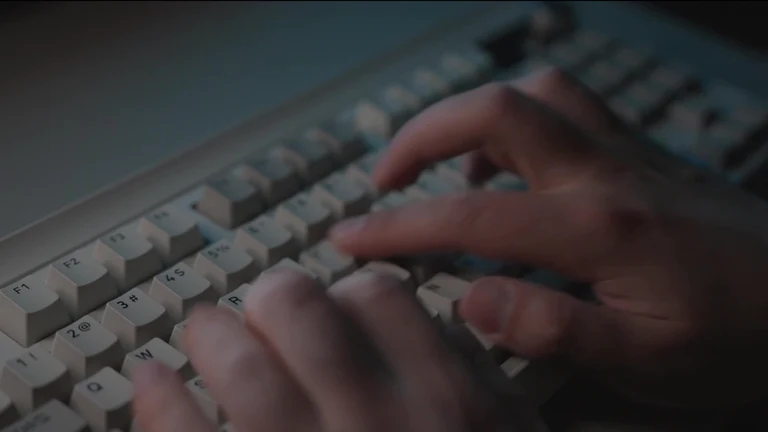 Hands typing on a keyboard
