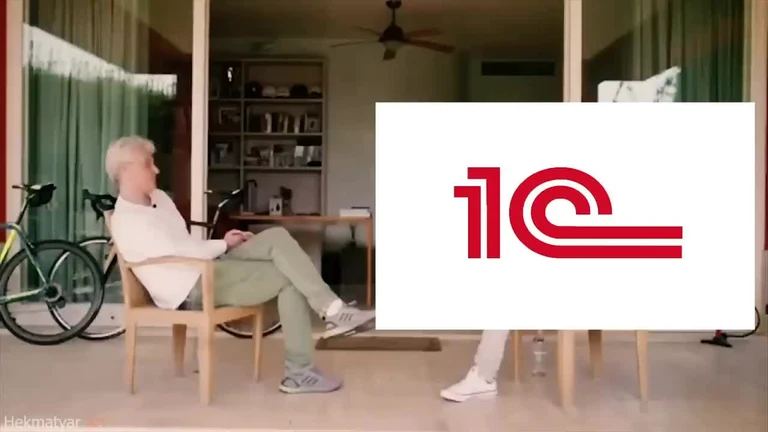 Man sitting in chair with 1C logo overlay