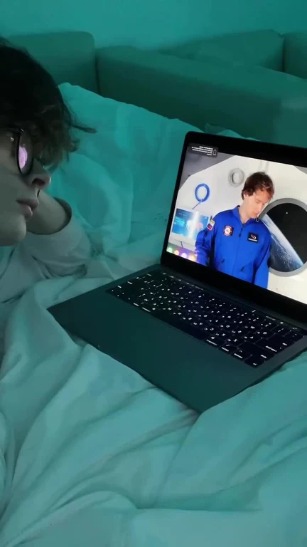 Person watching a video of an astronaut on a laptop
