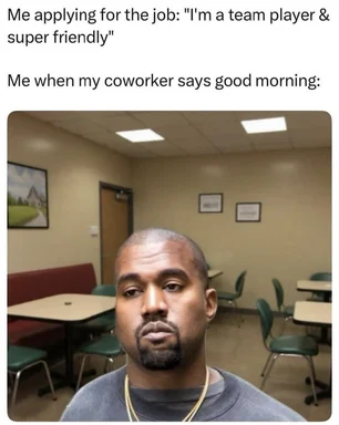 Meme with text 'Me applying for the job: I'm a team player & super friendly' and 'Me when my coworker says good morning:' above a photo of a man with a deadpan, unimpressed expression sitting in an office break room with tables and chairs.