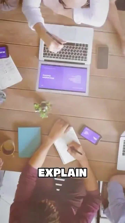 Overhead view of two people working at laptops with text 'EXPLAIN'