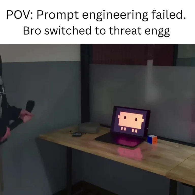 A person pointing a gun at a laptop with a pixelated face on the screen, captioned 'POV: Prompt engineering failed. Bro switched to threat engg'.