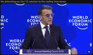 Man in suit and sunglasses at podium with World Economic Forum backdrop