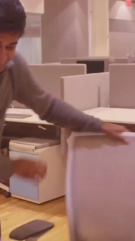 man throwing office chair in frustration