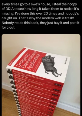 Stack of 'Designing Data-Intensive Applications' books with a humorous caption about stealing them
