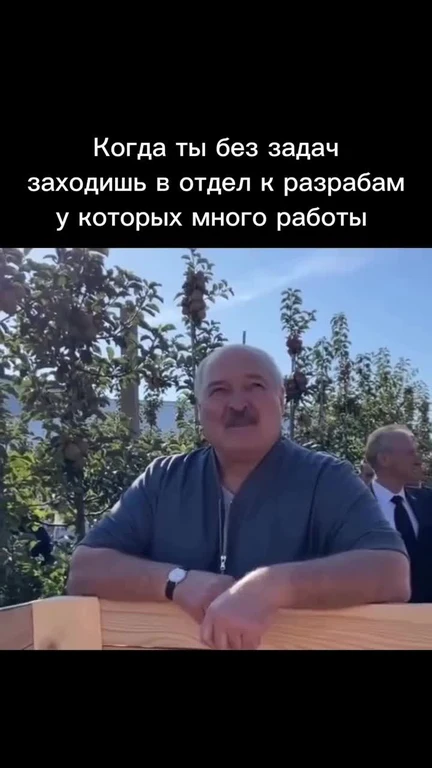 Man leaning on a wooden surface with a smug expression