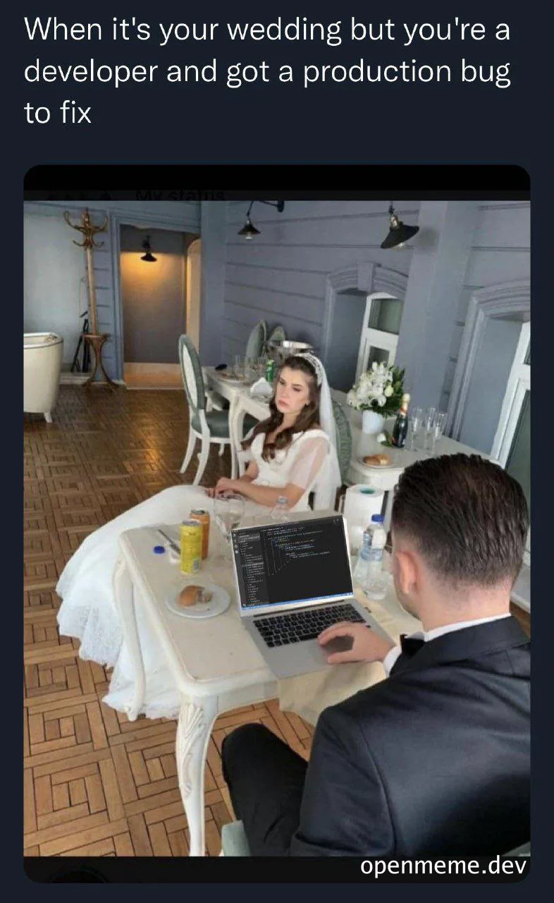 Bride and groom on wedding day, groom looking at laptop with bride looking on disapprovingly