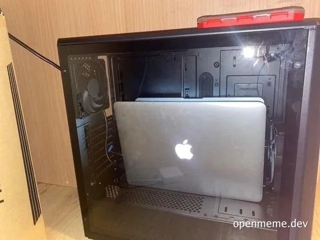 Apple laptop awkwardly fitted inside a computer tower
