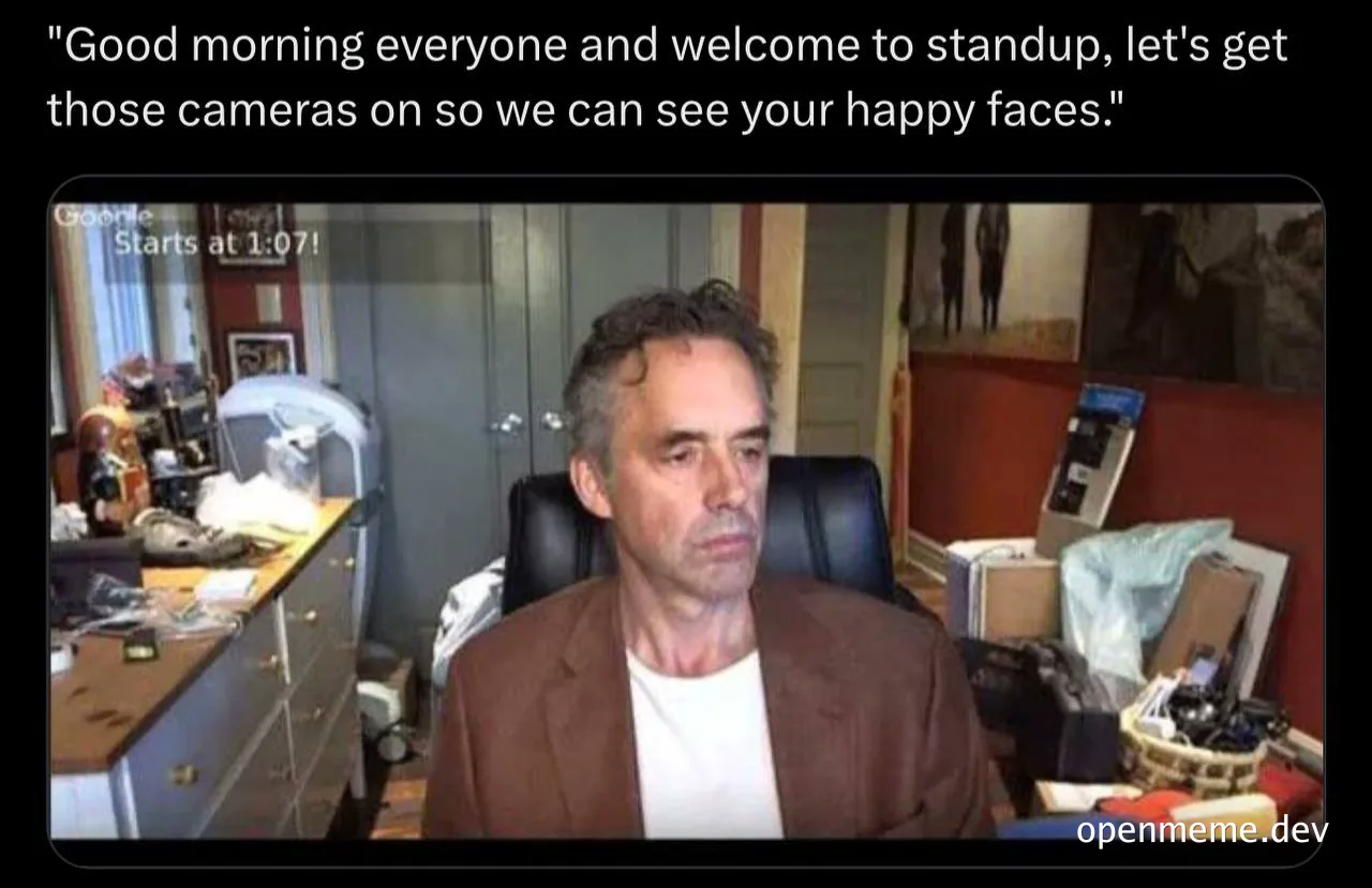 man in brown jacket on video call with messy office background