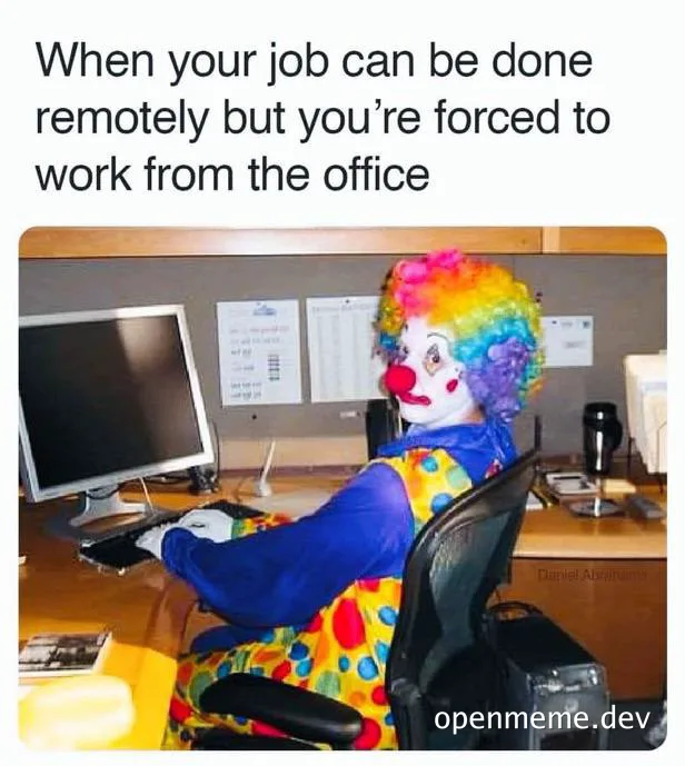 clown sitting at office desk with computer