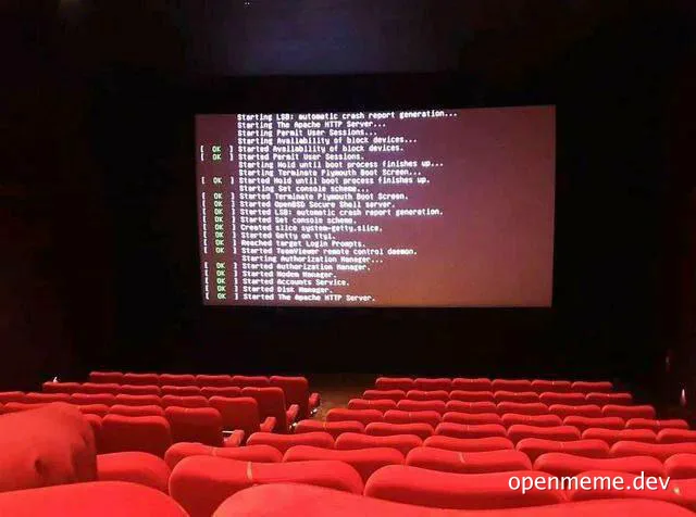 a movie theater with red seats and a screen displaying a server boot log