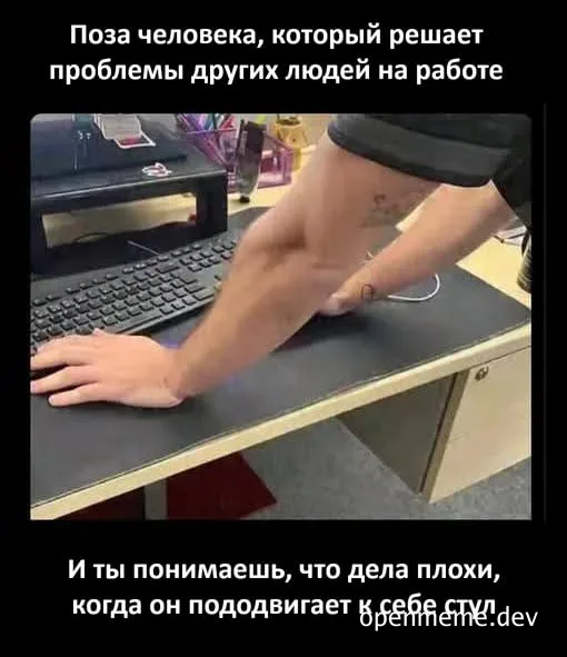 Man leaning on desk with arm muscles flexed