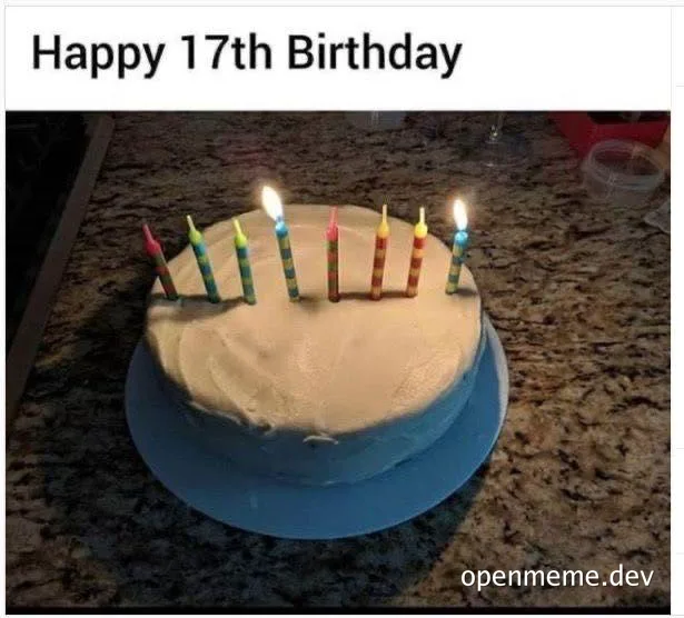 a white frosted cake with rainbow candles and two lit