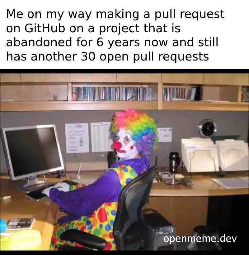 clown sitting at office desk with computer