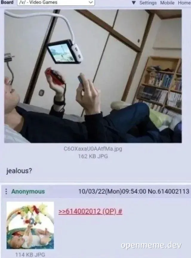 a man sitting on a couch playing video games with a jealous expression
