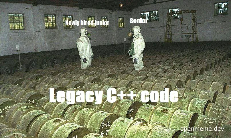 Two hazmat-suited developers standing in a warehouse full of barrels labeled Legacy C++ code