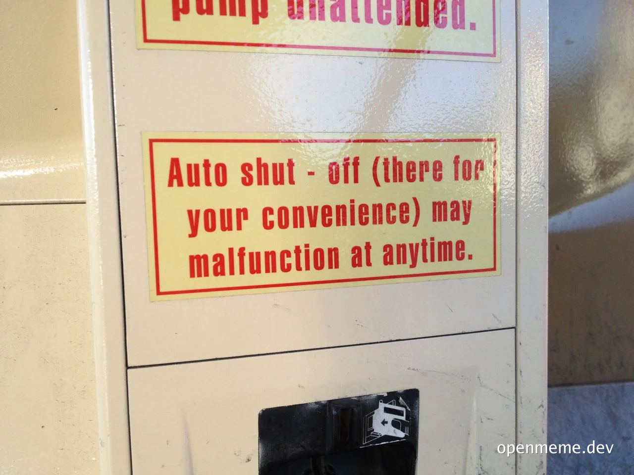 A close-up of a gas pump with a sticker that reads 'Auto shut-off (there for your convenience) may malfunction at anytime.'