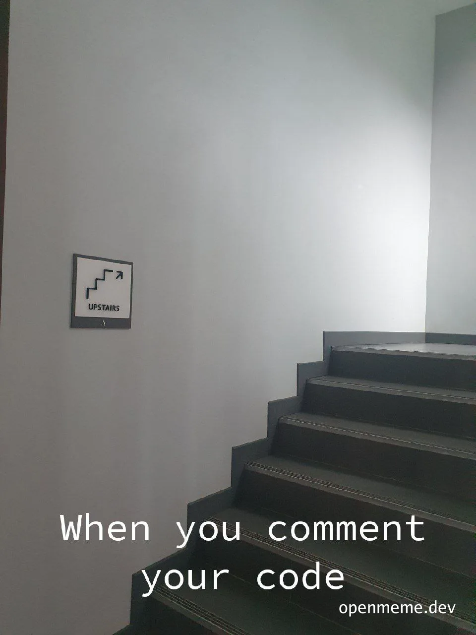 a staircase with a sign pointing upstairs and the text 'When you comment your code'