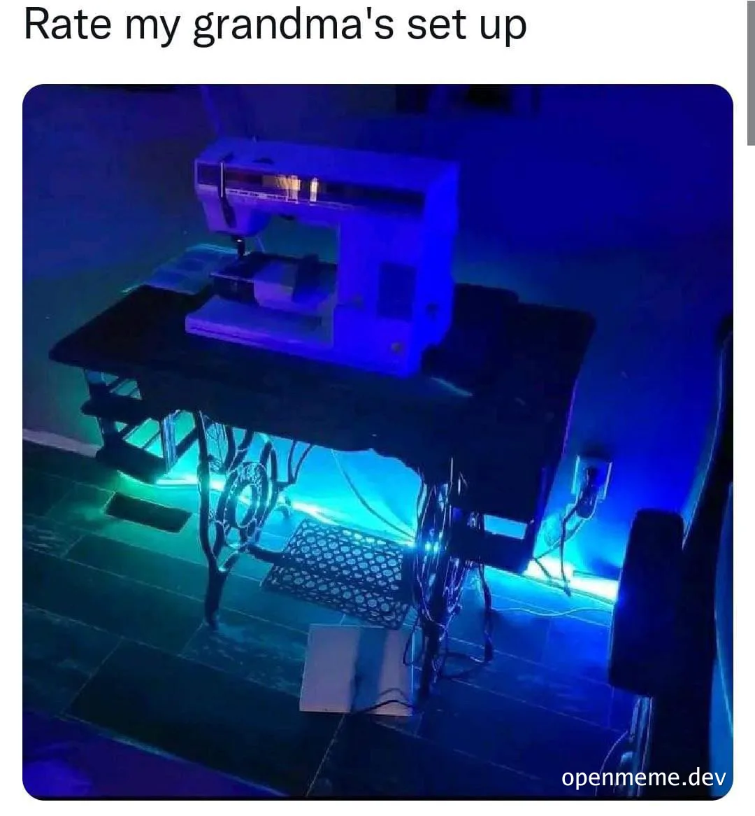 a sewing machine on a table with blue lights and a keyboard underneath