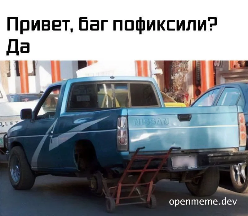 a blue pickup truck with a missing wheel and a dolly under it