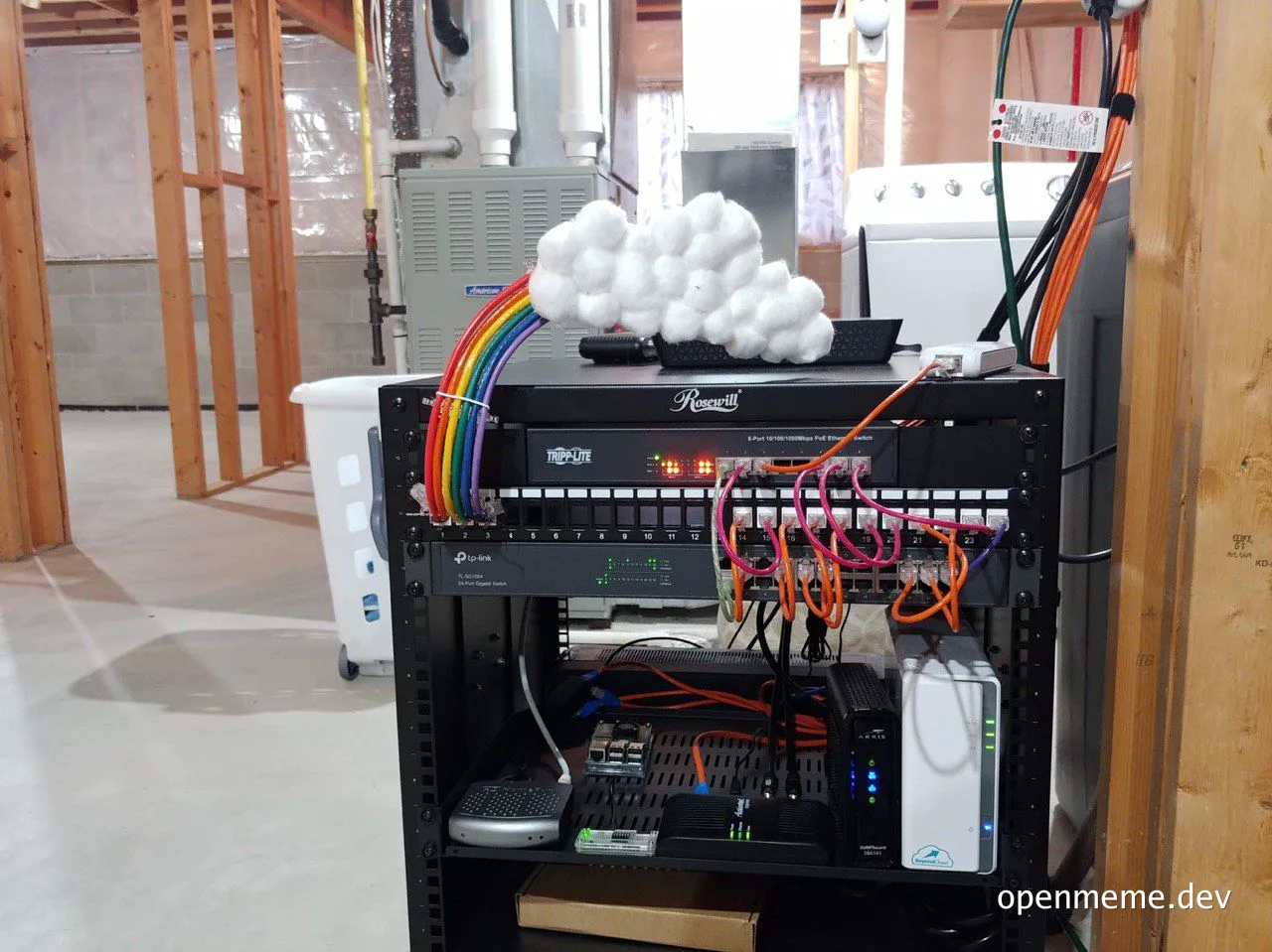 A server rack with cotton balls and a rainbow cable representing literal cloud computing