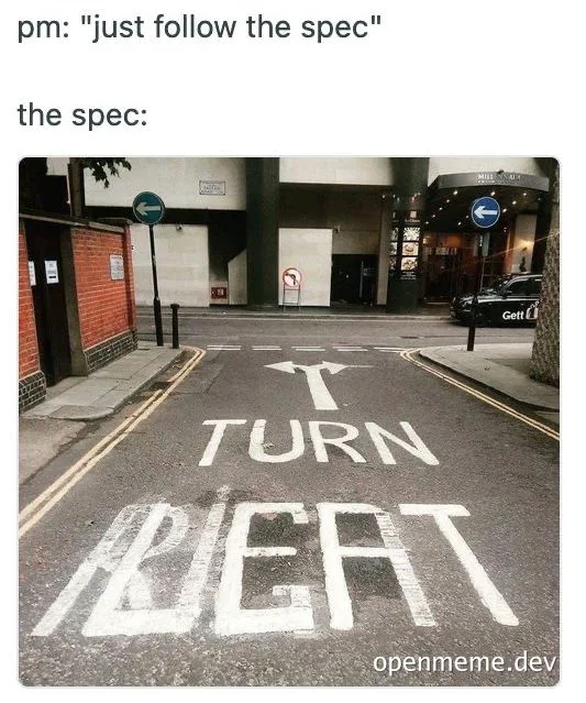 a road with white painted arrows and text that reads 'T TURN LEFT'